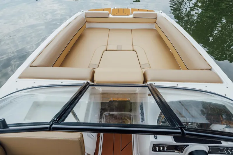Slide: The Image of Manufacturer Provided Image: 2025 Bayliner D20 boat interior with tan seating and sleek windshield design. - 4