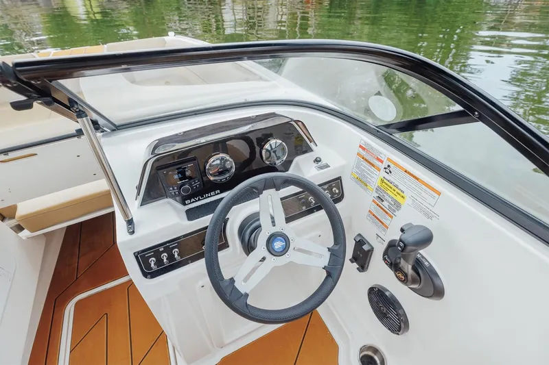 Slide: The Image of Manufacturer Provided Image: 2025 Bayliner D20 boat dashboard with steering wheel and control panel on water. - 5