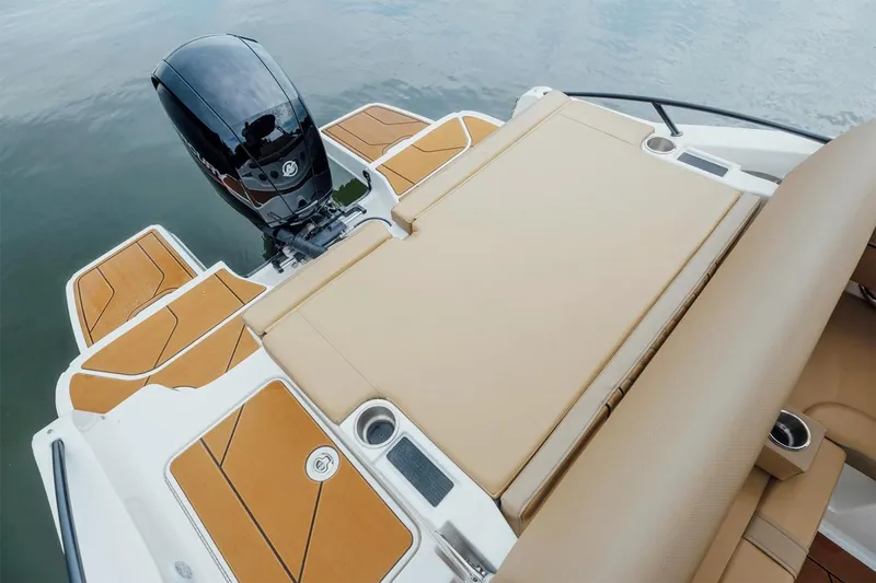 Slide: The Image of Manufacturer Provided Image: 2025 Bayliner D20 boat with tan seating and outboard motor on calm water. - 7