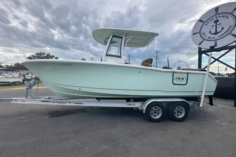 Slide: The Image of 2020 Sea Hunt Ultra 255 SE boat on trailer under cloudy sky. - 10