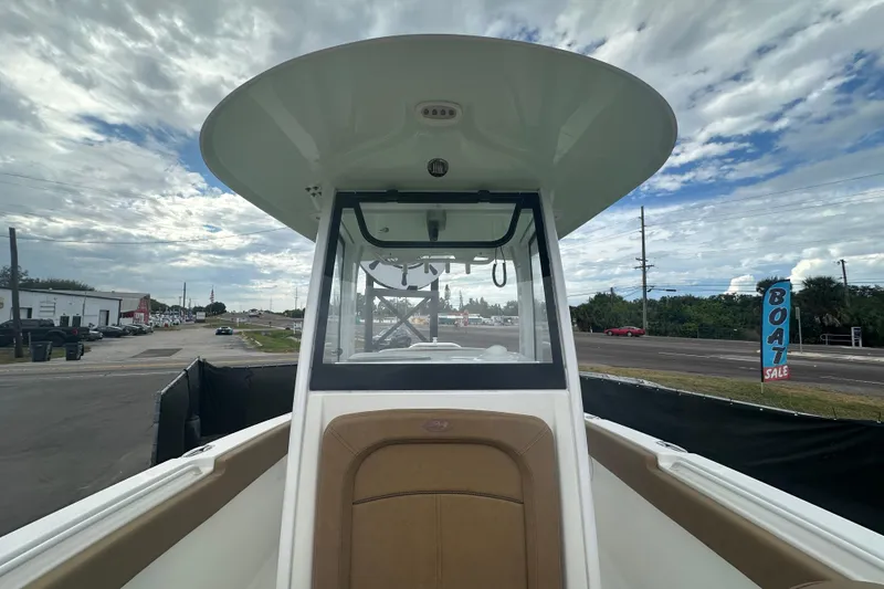 Slide: The Image of 2020 Sea Hunt Ultra 255 SE boat interior with tan cushioned seating. - 101