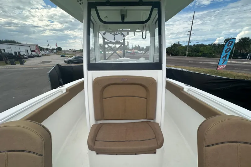 Slide: The Image of 2020 Sea Hunt Ultra 255 SE boat interior with brown seating and white deck. - 102