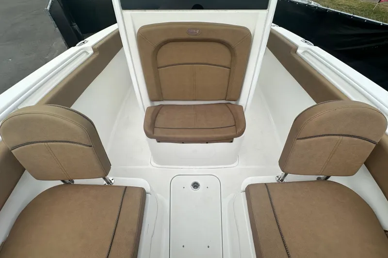 Slide: The Image of 2020 Sea Hunt Ultra 255 SE boat interior with brown seating and white deck. - 103