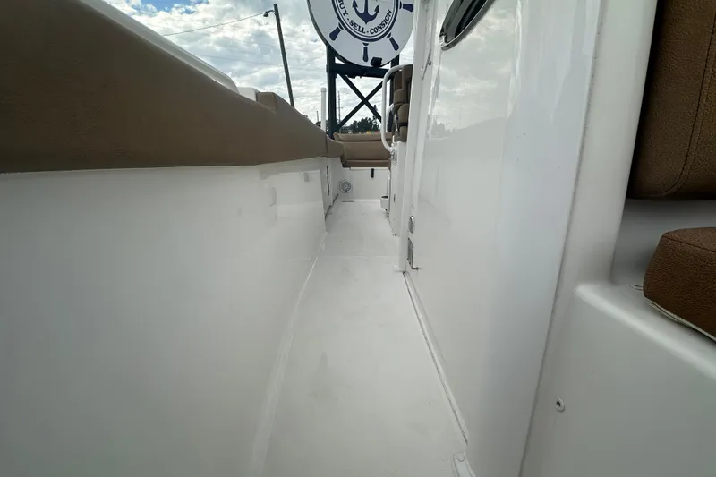 Slide: The Image of 2020 Sea Hunt Ultra 255 SE boat interior with tan seating and overhead view. - 104