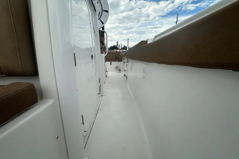 Slide: The Image of 2020 Sea Hunt Ultra 255 SE boat interior with tan seating and steering console. - 105