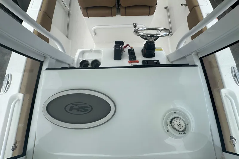 Slide: The Image of 2020 Sea Hunt Ultra 255 SE boat interior with storage compartment and cup holder. - 108