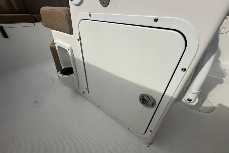 Slide: The Image of 2020 Sea Hunt Ultra 255 SE boat interior with brown seating and steering wheel. - 110