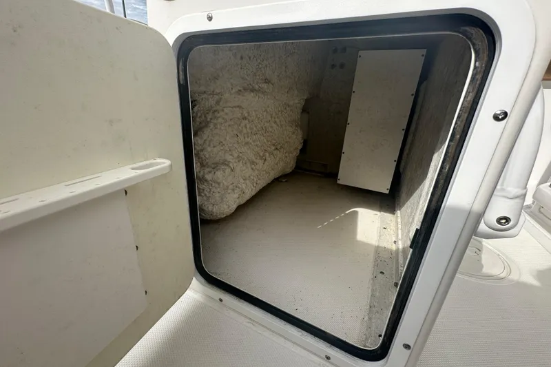 Slide: The Image of 2020 Sea Hunt Ultra 255 SE boat interior with seating and storage compartment. - 111