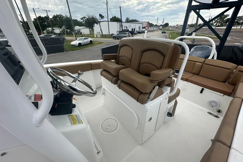 Slide: The Image of Open storage compartment on 2020 Sea Hunt Ultra 255 SE boat, featuring multiple shelves. - 112