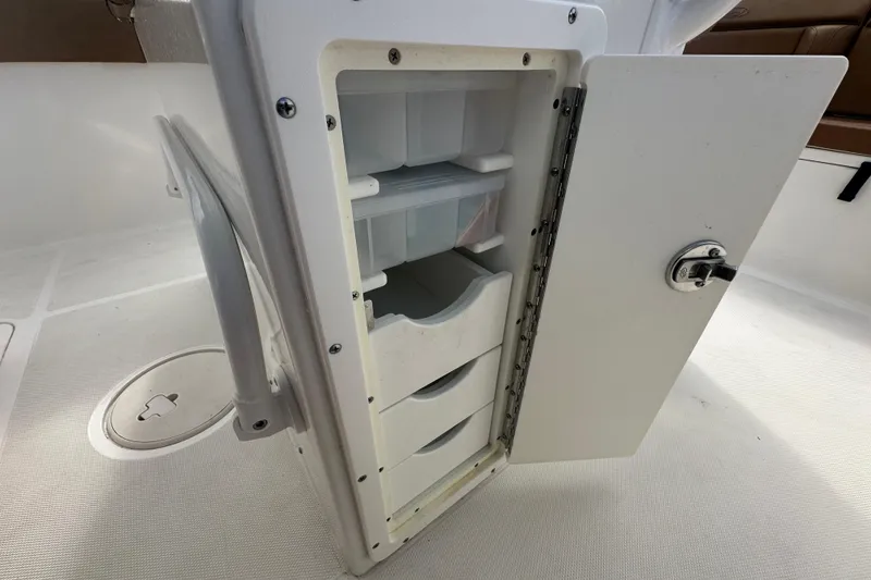 Slide: The Image of Open storage compartment on 2020 Sea Hunt Ultra 255 SE boat. - 114