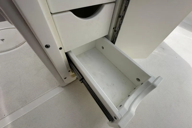 Slide: The Image of Open storage compartment on a 2020 Sea Hunt Ultra 255 SE boat. - 115