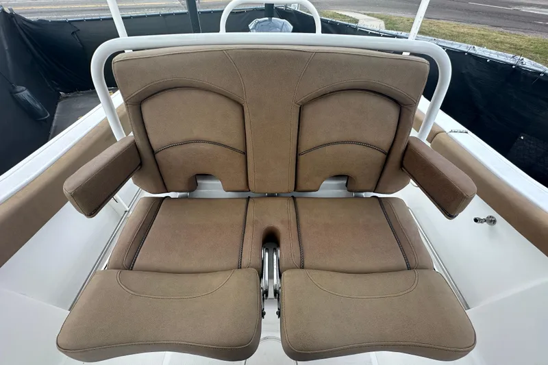 Slide: The Image of 2020 Sea Hunt Ultra 255 SE boat with tan seating, displayed at a dealership. - 120