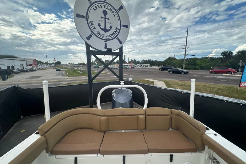 Slide: The Image of 2020 Sea Hunt Ultra 255 SE boat interior with brown seating and cup holders. - 122