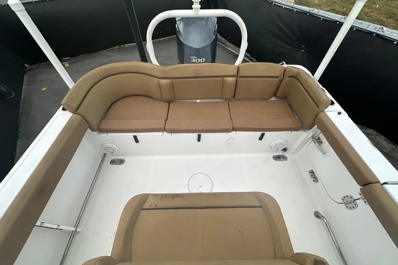 Slide: The Image of 2020 Sea Hunt Ultra 255 SE boat interior with brown cushioned seating. - 123