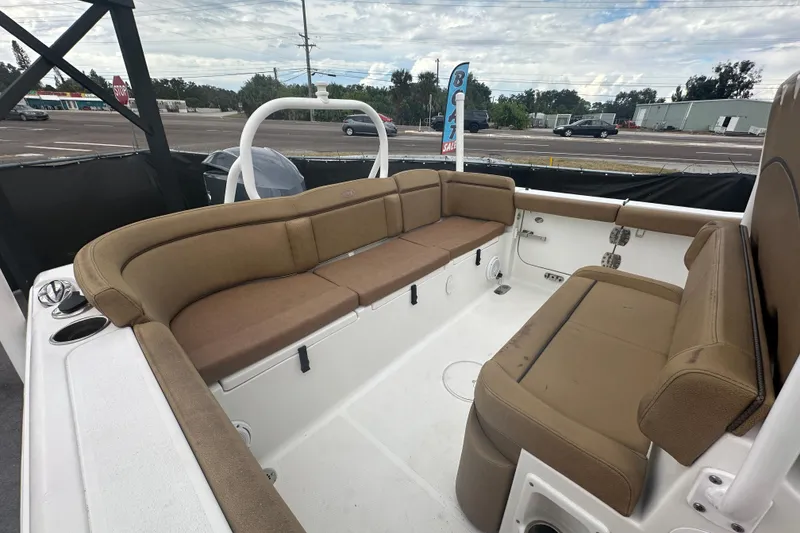 Slide: The Image of 2020 Sea Hunt Ultra 255 SE boat with Yamaha 300 engine, tan seating, and outdoor view. - 124
