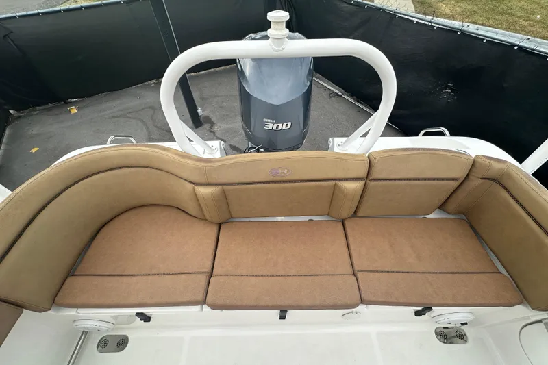 Slide: The Image of 2020 Sea Hunt Ultra 255 SE boat interior with storage compartment and cushioned seating. - 127