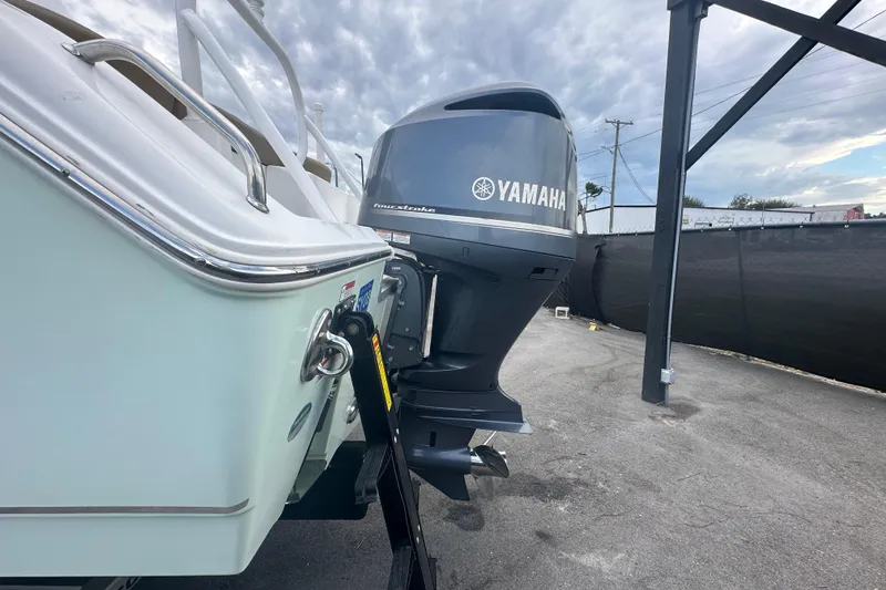 Slide: The Image of 2020 Sea Hunt Ultra 255 SE with Yamaha outboard motor, parked outdoors. - 13