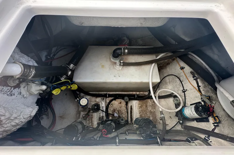 Slide: The Image of 2020 Sea Hunt Ultra 255 SE boat seating area with storage compartment. - 135