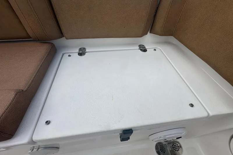 Slide: The Image of 2020 Sea Hunt Ultra 255 SE boat compartment with visible wiring and hoses. - 137