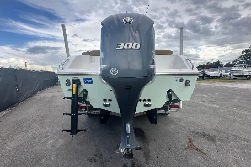 Slide: The Image of 2020 Sea Hunt Ultra 255 SE boat with Yamaha 300 outboard motor, parked outdoors. - 14
