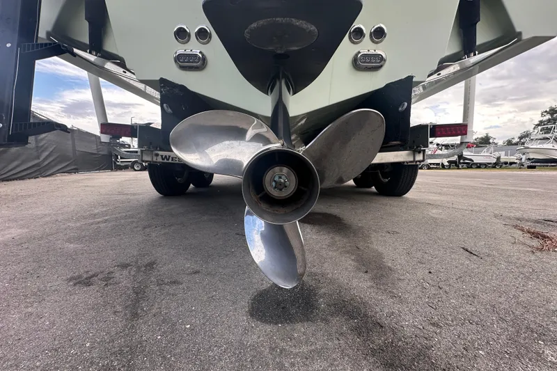 Slide: The Image of 2020 Sea Hunt Ultra 255 SE boat interior with tan seating, docked among other boats. - 18