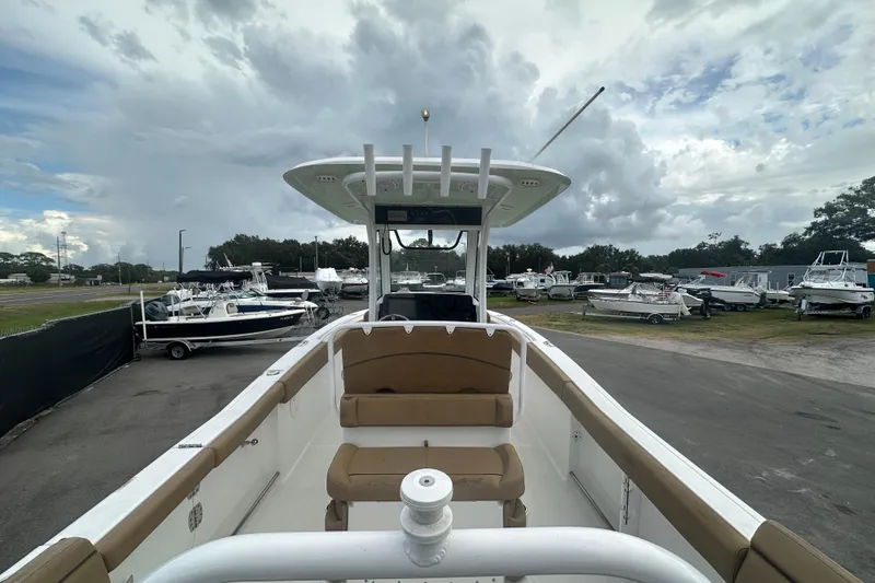 Slide: The Image of 2020 Sea Hunt Ultra 255 SE boat interior with brown seating and white railing. - 19