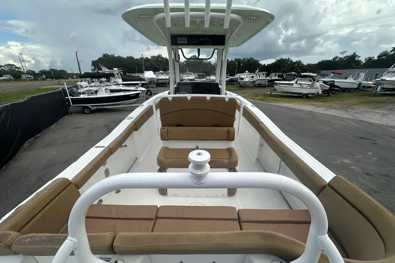 Slide: The Image of 2020 Sea Hunt Ultra 255 SE boat with tan seating, docked at a marina. - 20