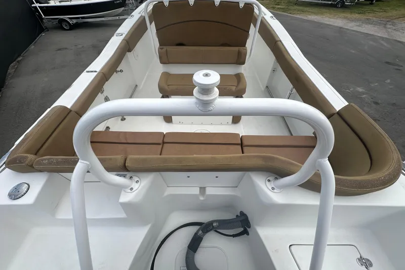 Slide: The Image of 2020 Sea Hunt Ultra 255 SE boat interior with tan seating, docked among other boats. - 21