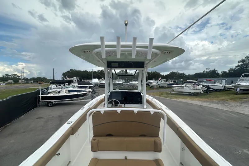 Slide: The Image of 2020 Sea Hunt Ultra 255 SE boat interior with tan seating and spacious layout. - 22