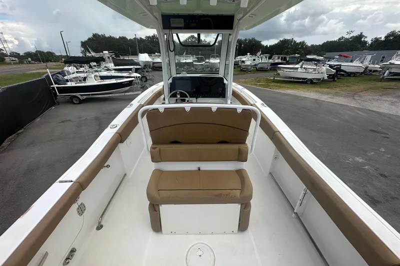 Slide: The Image of 2020 Sea Hunt Ultra 255 SE boat interior with seating and overhead view. - 23