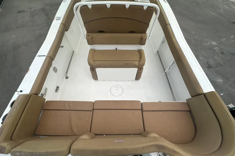 Slide: The Image of 2020 Sea Hunt Ultra 255 SE boat interior with tan seating and white deck. - 24