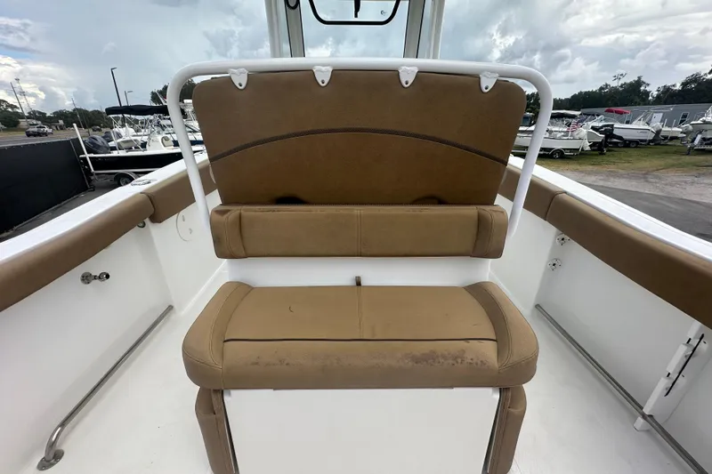 Slide: The Image of 2020 Sea Hunt Ultra 255 SE boat interior with tan seating and storage compartment. - 26