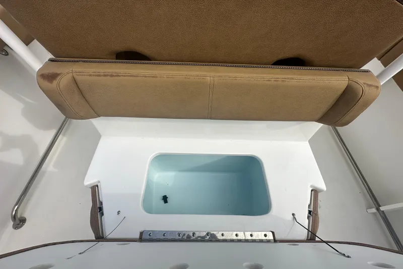 Slide: The Image of 2020 Sea Hunt Ultra 255 SE boat interior with tan seating and white deck. - 28