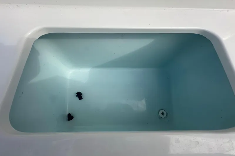 Slide: The Image of 2020 Sea Hunt Ultra 255 SE boat interior with foldable seat and brown upholstery. - 29