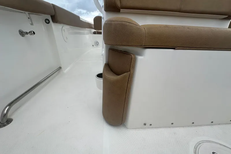 Slide: The Image of 2020 Sea Hunt Ultra 255 SE boat interior with tan seating and stainless steel hardware. - 30