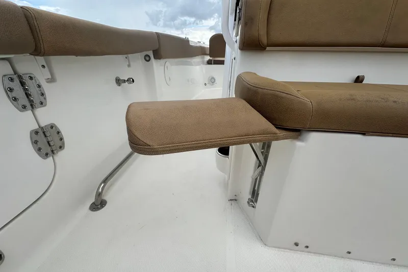 Slide: The Image of Interior view of 2020 Sea Hunt Ultra 255 SE boat with brown seating and white flooring. - 31