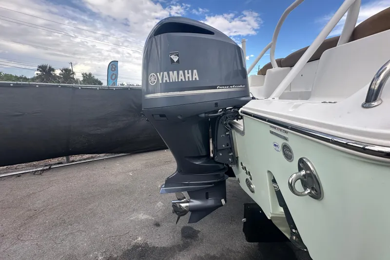 Slide: The Image of 2020 Sea Hunt Ultra 255 SE with Yamaha outboard motor, parked outdoors. - 4
