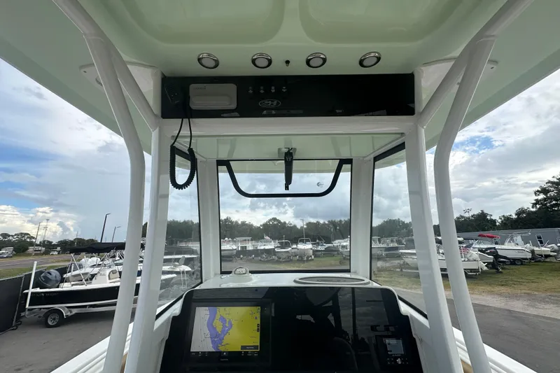 Slide: The Image of 2020 Sea Hunt Ultra 255 SE boat windshield view with marina background. - 43