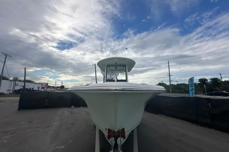 Slide: The Image of 2020 Sea Hunt Ultra 255 SE boat on display under a cloudy sky. - 5
