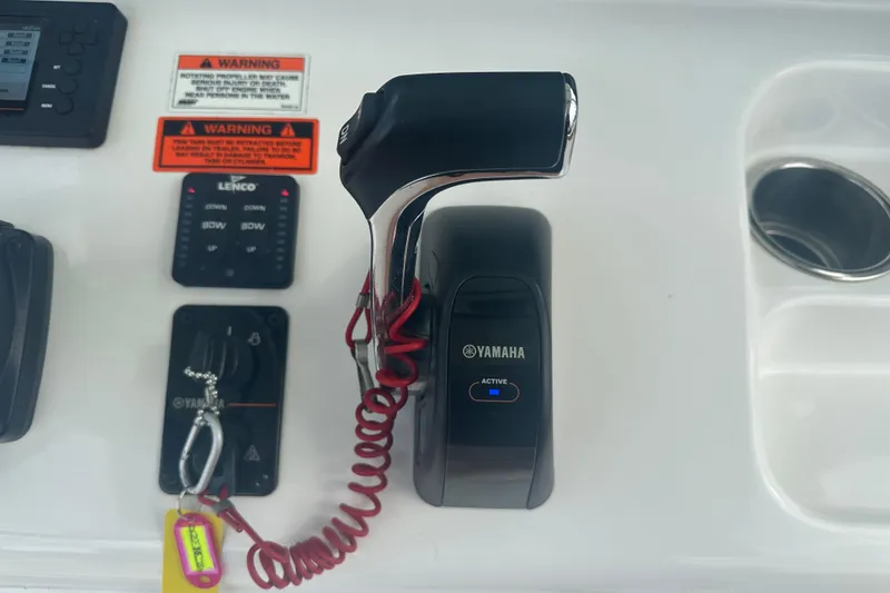 Slide: The Image of Steering wheel and controls of 2020 Sea Hunt Ultra 255 SE boat. - 55