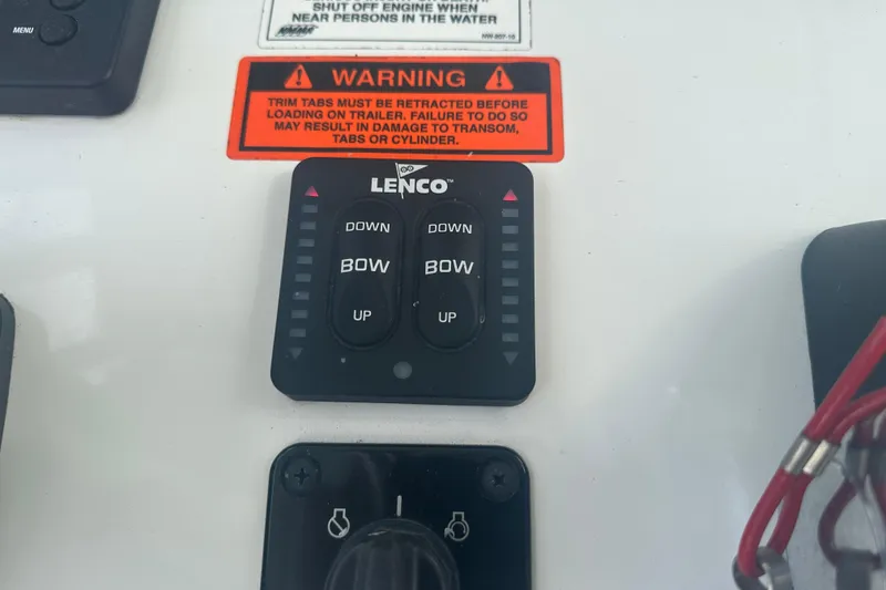 Slide: The Image of 2020 Sea Hunt Ultra 255 SE boat console with storage compartments and warning label. - 56