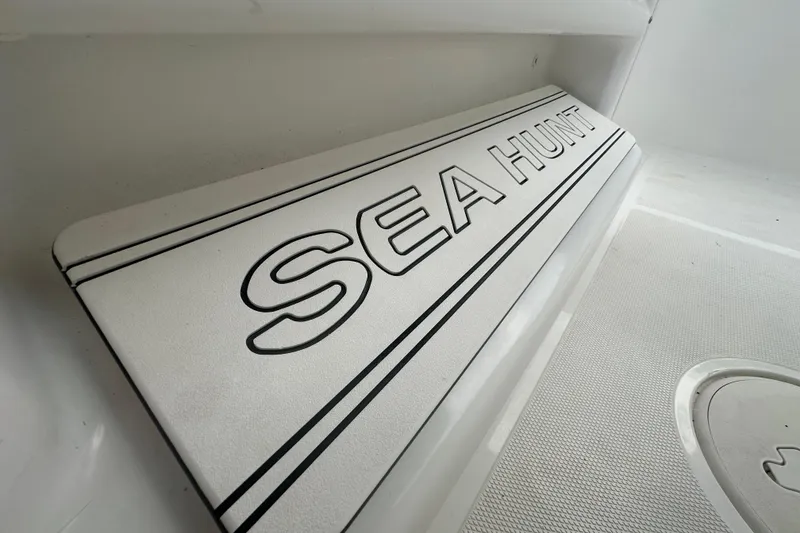 Slide: The Image of Compass on 2020 Sea Hunt Ultra 255 SE boat, with marina view in background. - 62