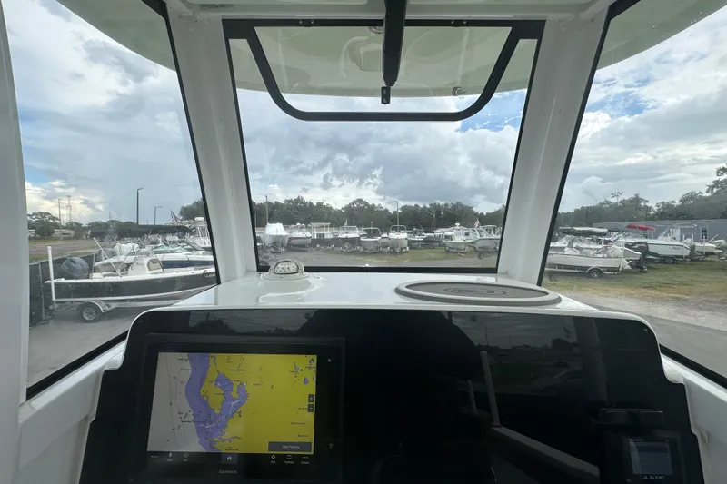 Slide: The Image of 2020 Sea Hunt Ultra 255 SE boat interior with logo detail, surrounded by other boats. - 63