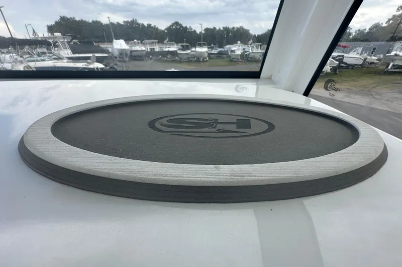 Slide: The Image of 2020 Sea Hunt Ultra 255 SE boat interior with open door revealing compact toilet. - 65
