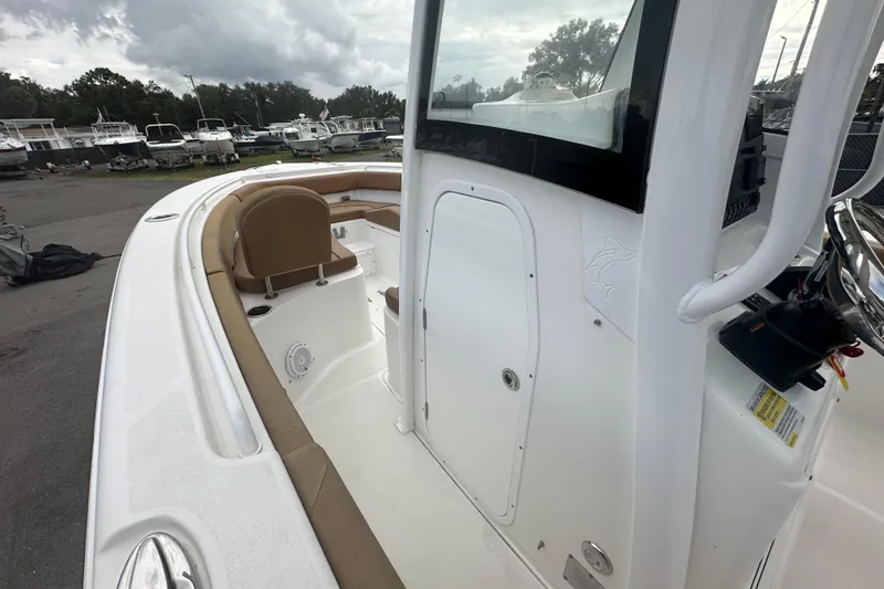 Slide: The Image of 2020 Sea Hunt Ultra 255 SE boat interior with toilet and storage compartments. - 66