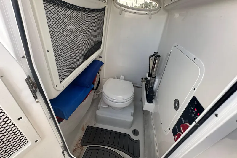 Slide: The Image of 2020 Sea Hunt Ultra 255 SE boat interior with control panel and toilet. - 68