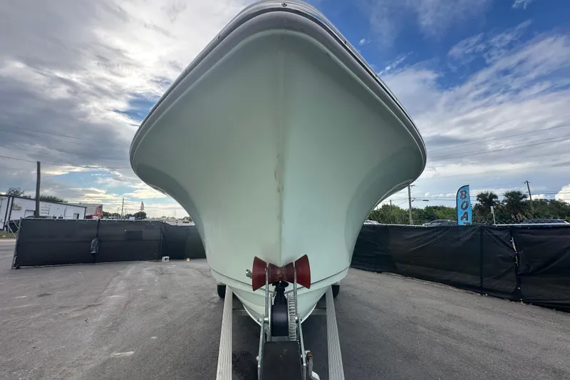 Slide: The Image of 2020 Sea Hunt Ultra 255 SE boat on trailer, viewed from front under cloudy sky. - 7