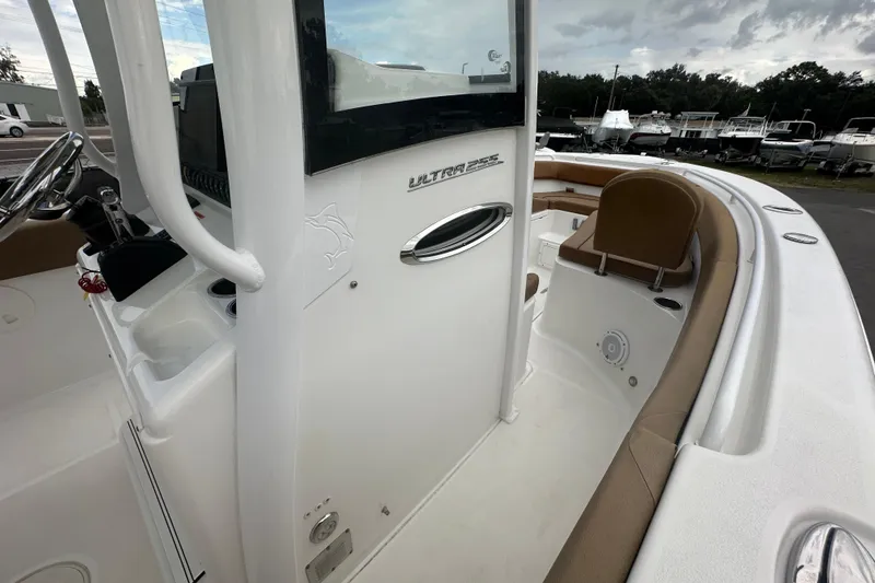 Slide: The Image of 2020 Sea Hunt Ultra 255 SE boat with tan seating, docked among other boats. - 72