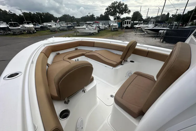 Slide: The Image of 2020 Sea Hunt Ultra 255 SE boat with tan seating, parked among other boats. - 74