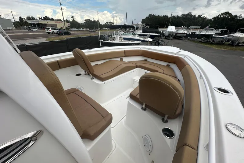 Slide: The Image of 2020 Sea Hunt Ultra 255 SE boat interior with tan seating and white deck. - 75
